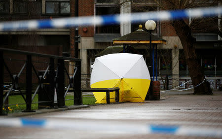 A tent covers the park bench where former Russian intelligence agent Sergei Skripal and his daughter Yulia were found after they were poisoned, in Salisbury, Britain March 12, 2018. REUTERS/Henry Nicholls