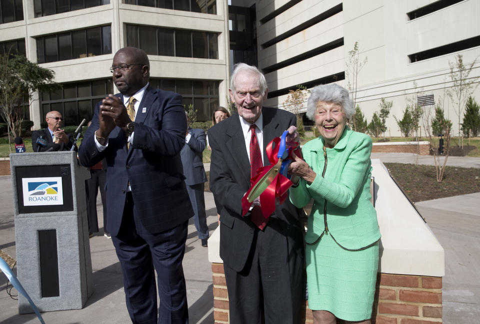 FILE - Roanoke, Va., Mayor Sherman Lea, left, applauds after former Virginia Gov Gov. A. Linwood Holton Jr., and his wife Virginia "Jinks" Rogers Holton cut the ribbon for the dedication of the newly renovated Linwood Plaza in downtown Roanoke, Va. on Oct. 16, 2017. Virginia Holton died Friday, Dec. 16, 2022, at her home, her family said in a statement. She was 97. (Stephanie Klein-Davis/The Roanoke Times via AP, File)