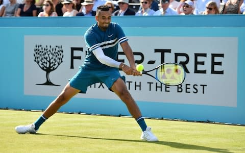 Australia's Nick Kyrgios returns to Britain's Andy Murray during their first round men's singles match at the ATP Queen's Club Championships tennis tournament in west London on June 19, 2018 - Credit: AFP