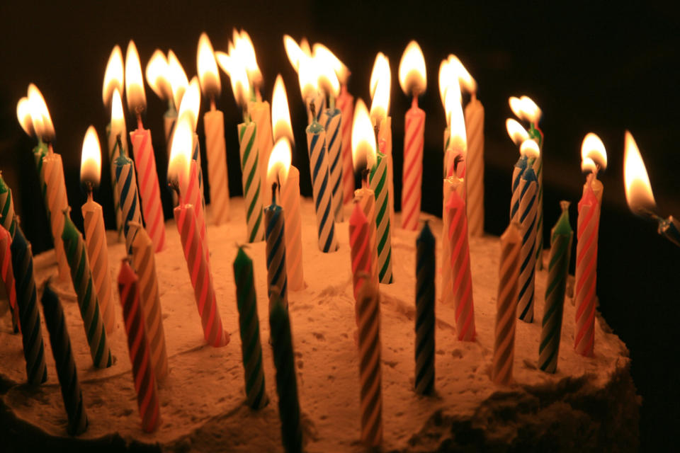 Candles lit on a cake.