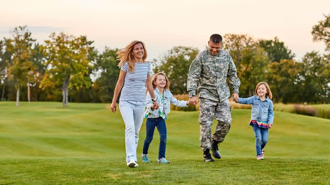 Happy family walking on the grass.