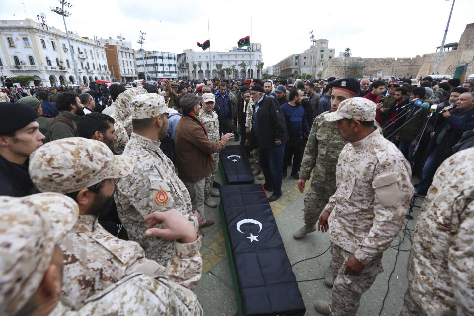 Soldiers stand by the coffins during a funeral of military cadets in Tripoli, Libya, Sunday, Jan. 5, 2020. Health officials said the death toll from the airstrike climbed to at least 30 people, most of them students and over 30 others were wounded. The airstrike took place in the city's south late Saturday, an area which has seen heavy clashes in recent months. Forces based in eastern Libya and led by Gen. Khalifa Hifter have been fighting to seize the capital from the weak but U.N.-supported government. (AP Photo/Hazem Ahmed)