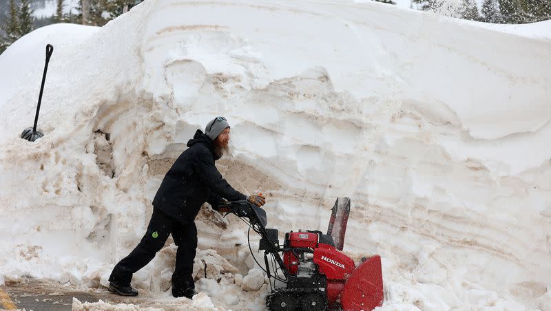 Wesley Seybold snowblowing a wall of snow to reclaim his driveway Monday, March 13, 2023, in Brighton.