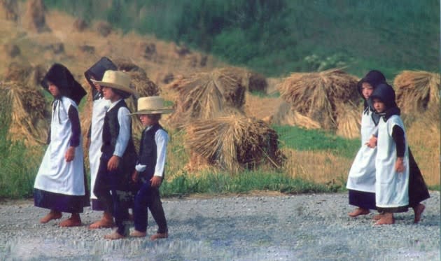 Gingerich (far left), her cousins, and siblings, walk to church as children (Undated tourist photo)