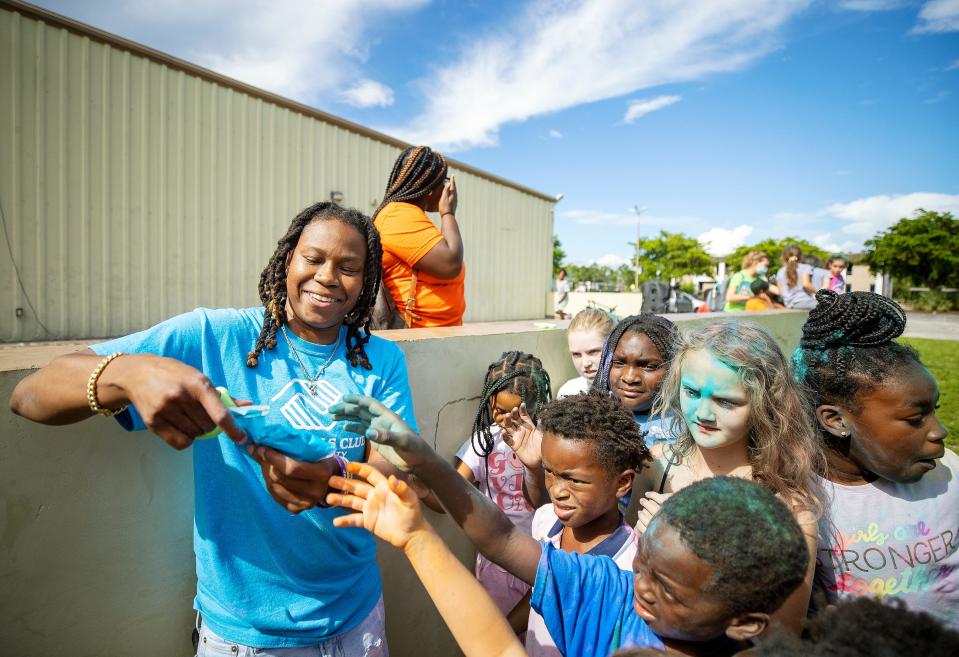 Keri Jewett-Giles plays color rush recently with kids at the new Boys and Girls Club on Park Meadows Drive in Fort Myers. Jewett-Giles is the clubÕs director. Jewett-Giles was a star basketball player at Dunbar High School, FGCU and played professionally. 