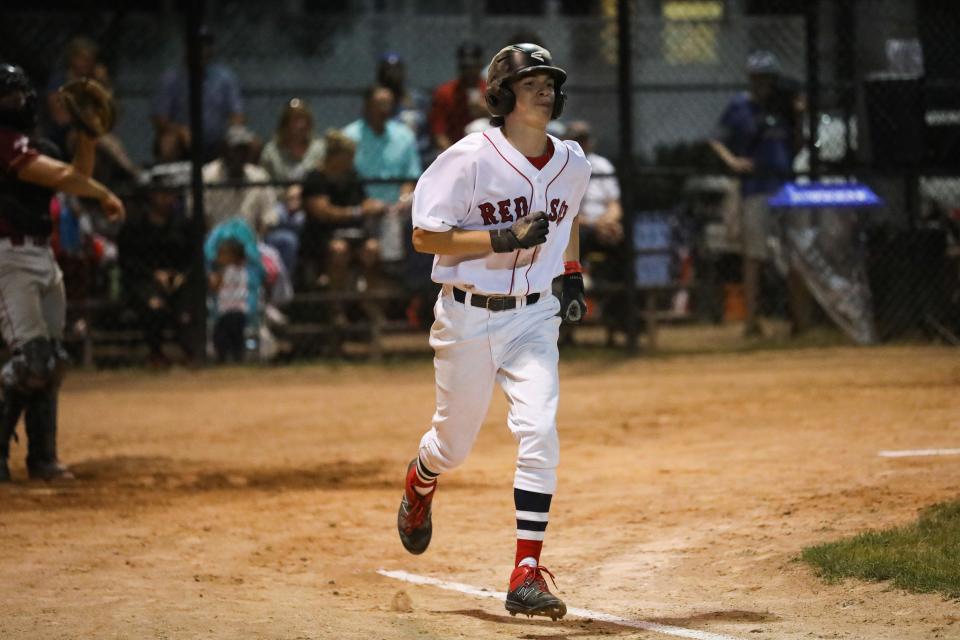 Joe Corsi, the son of the the late Red Sox pitcher Jim Corsi, jogs to first base during the 28th annual Abbot Financial Management Oldtime Baseball Game in Cambridge, Aug. 24, 2022.