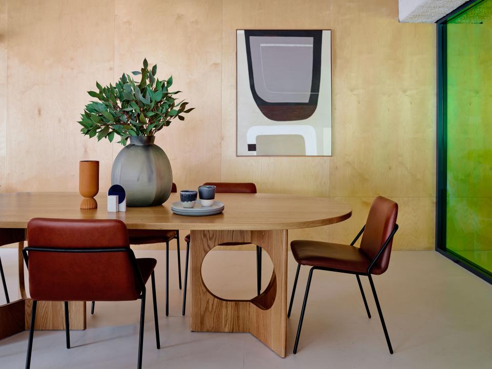 The elegant lines in the table and chairs are echoed in the abstract artwork on the wall by Leonie Barton.