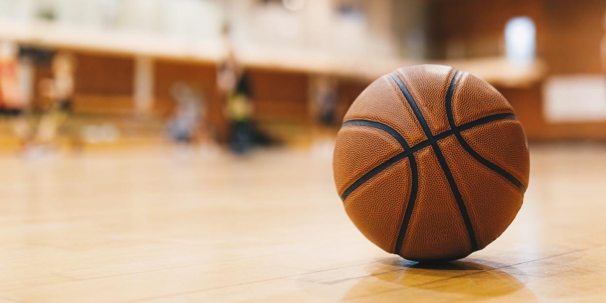 A stock photo of a basketball on a court.