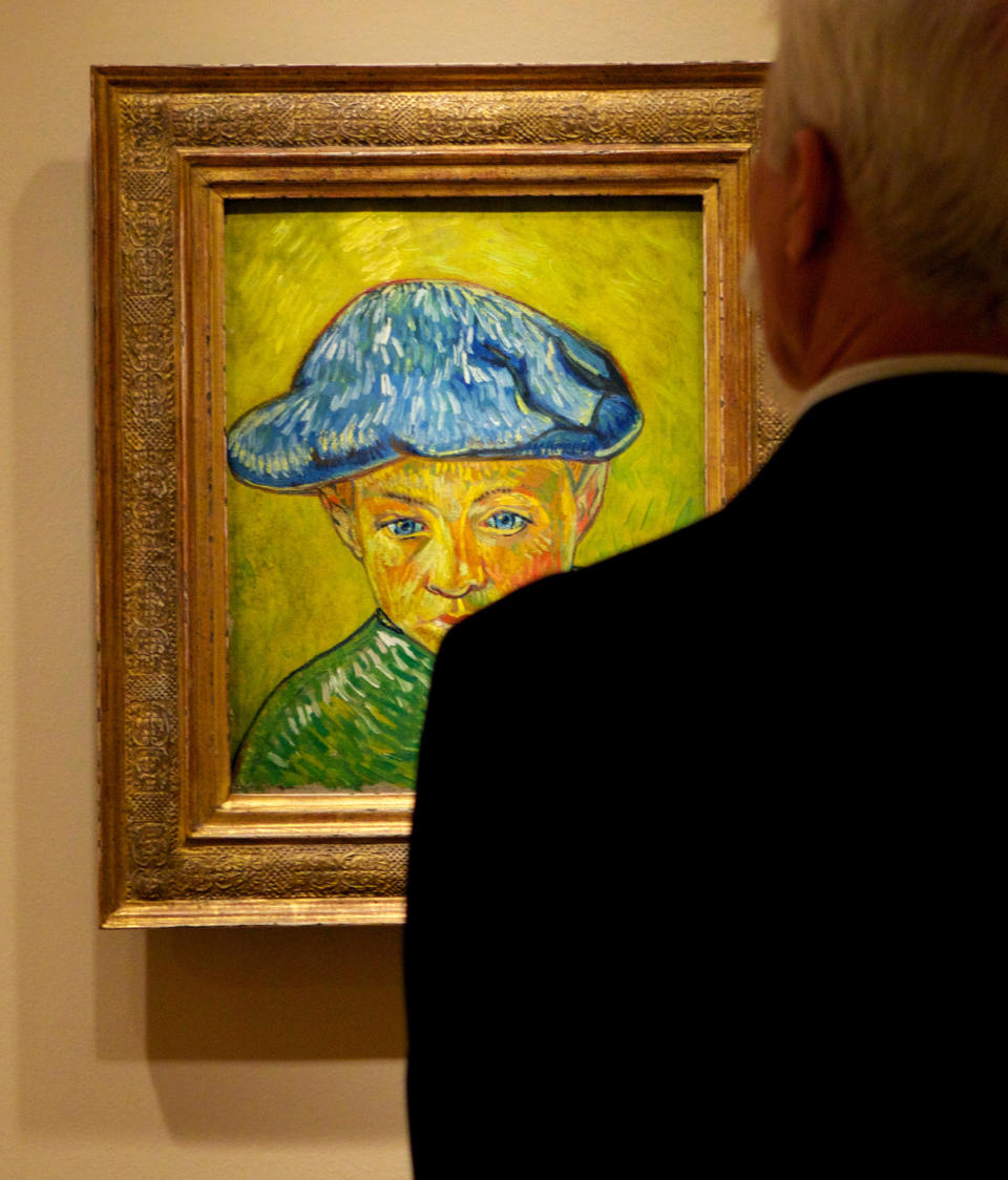 In this Oct. 8, 2013 photo, a visitor studies Vincent van Gogh's "Portrait of Camille Roulin," on display at The Phillips Collection in Washington. In the midst of the shutdown of federally funded museums, the private Phillips Collection is launching the first major exhibition of Vincent van Gogh’s artwork in Washington in 15 years. (AP Photo/Molly Riley)