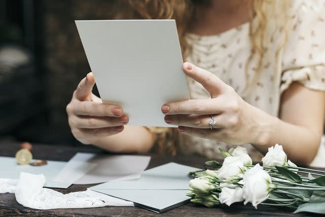 <p>Getty</p> A woman holding stationery