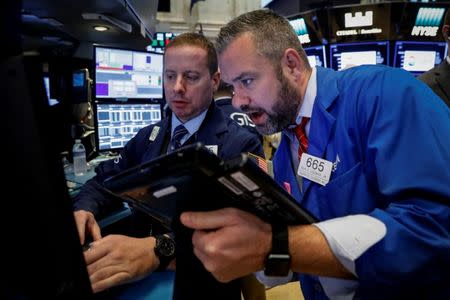 Traders work on the floor of the New York Stock Exchange (NYSE) in New York, U.S., October 20, 2017. REUTERS/Brendan McDermid