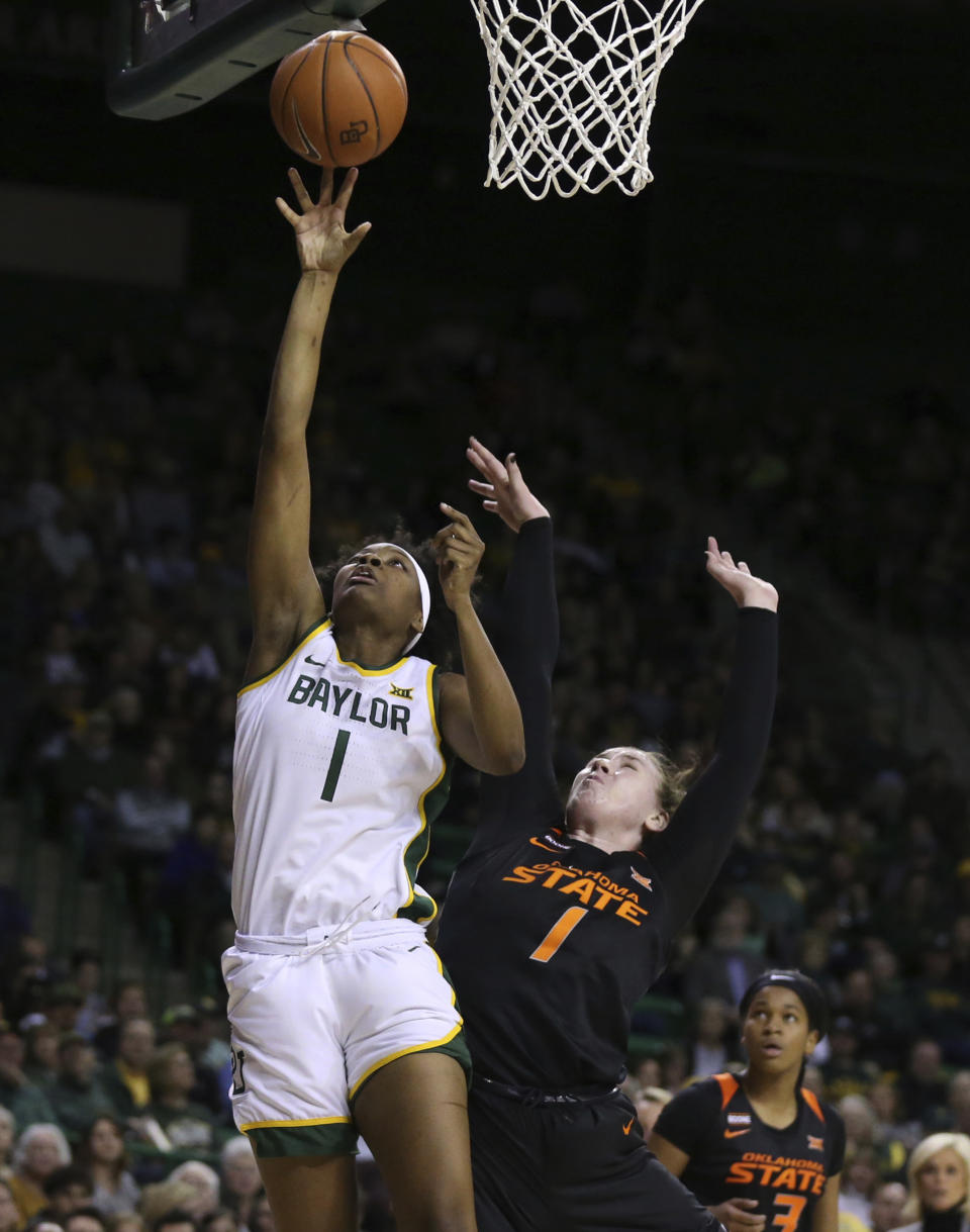 Baylor forward NaLyssa Smith, left, scores over Oklahoma State center Kassidy De Lapp, right, in the second half of an NCAA college basketball game, Sunday, Jan. 12, 2020, in Waco, Texas. (Rod Aydelotte/Waco Tribune Herald via AP)