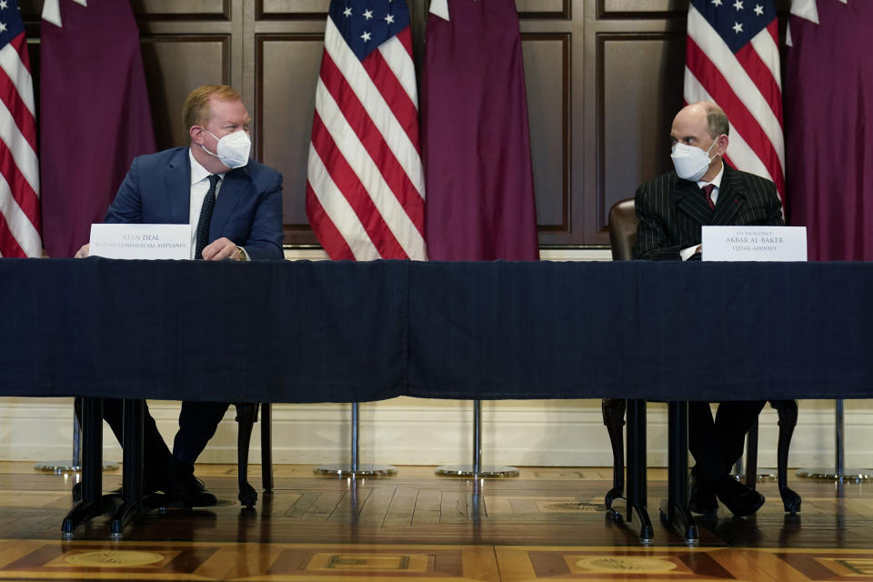 Stan Deal, President and CEO Boeing Commercial Airplanes, left, and Qatar Airways' CEO Akbar al-Baker prepare to sign agreements for the purchase of thirty-four 777-8 Freighter planes with purchase rights for an additional sixteen, in the Eisenhower Executive Office Building on the White House Campus in Washington, Monday, Jan. 31, 2022. They also signed a letter of intent for an additional purchase from Qatar Airways of twenty-five 737-10s , worth $6.7 billion. (AP Photo/Carolyn Kaster)