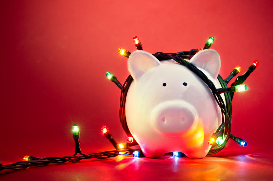 Piggy bank wrapped in Christmas string lights. Photo: Getty