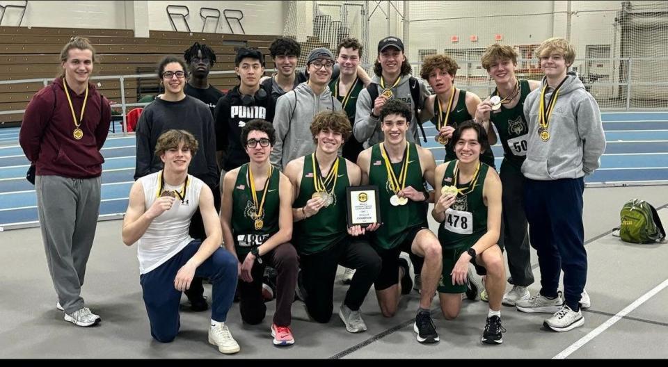 Members of the Nashoba boys' indoor track team celebrate their Mid-Wach B championship victory on Saturday at the Reggie Lewis Center.