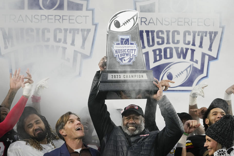 Maryland head coach Mike Locksley hoists the trophy after winning the Music City Bowl NCAA college football game 31-13 against Auburn, Saturday, Dec. 30, 2023, in Nashville, Tenn. (AP Photo/George Walker IV)