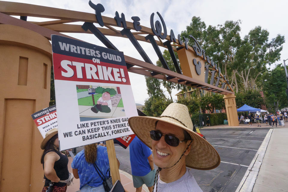 Striking writers walk outside the gates of Walt Disney Studios in Burbank, Calif., Thursday, Sep. 21, 2023. Negotiations between striking screenwriters and Hollywood studios have resumed and will continue Thursday, the latest attempt to bring an end to pickets that have brought film and television productions to a halt. (AP Photo/Damian Dovarganes)