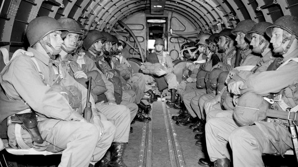 PHOTO: American paratroopers, heavily armed, sit inside a military plane as they soar over the English Channel en route to the Normandy French coast for the Allied D-Day invasion of the German stronghold during World War II, June 6, 1944.  (AP)