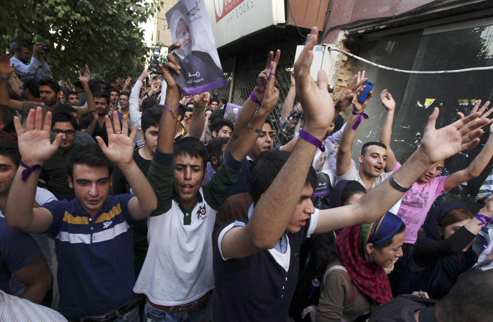 Supporter of the Iranian presidential candidate Hassan Rouhani celebrate outside his campaign headquarters in Tehran, Iran, Saturday, June 15, 2013. (AP Photo/Vahid Salemi)