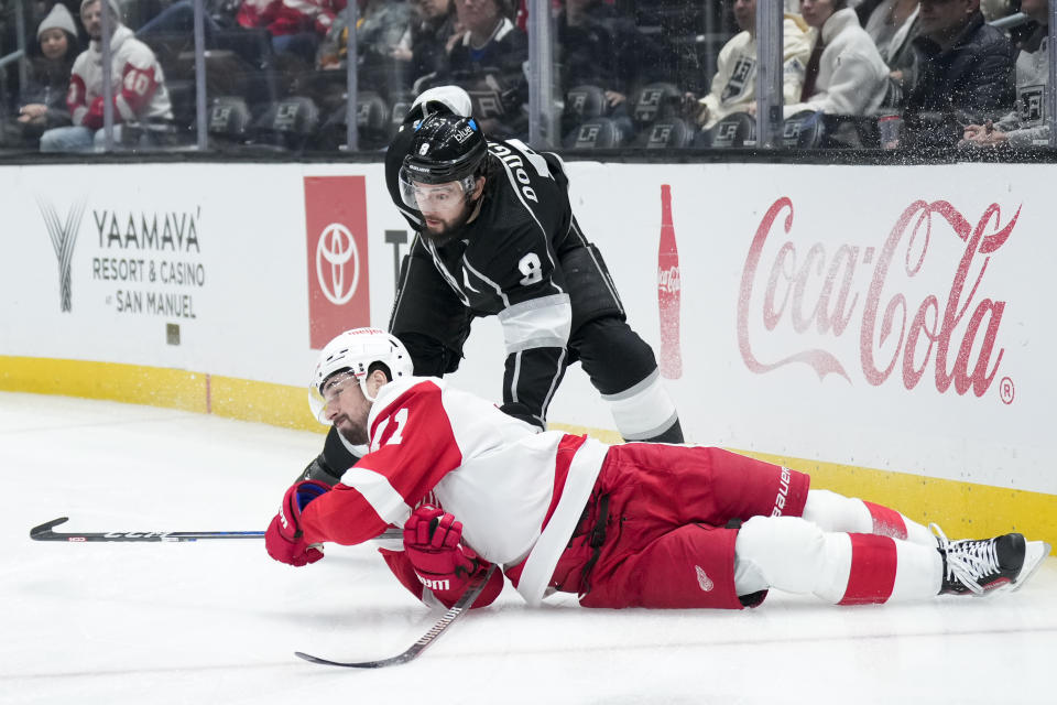 Detroit Red Wings center Dylan Larkin (71) falls to the ice while being pressured by Los Angeles Kings right wing Adrian Kempe (9) during the first period of an NHL hockey game Thursday, Jan. 4, 2024, in Los Angeles. (AP Photo/Jae C. Hong)