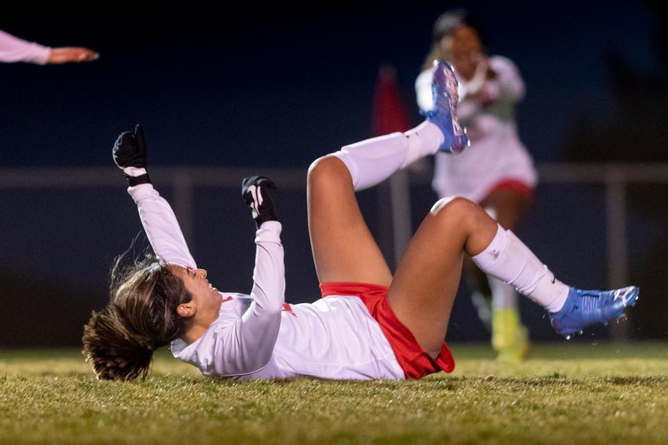 Oak Hills' Sydney Middaugh falls to the ground as she celebrates after scoring a goal against Serrano on Jan. 19, 2022. Oak Hills won the match 4-0.