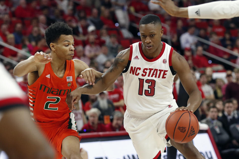 Miami guard Isaiah Wong (2) guards North Carolina State guard C.J. Bryce (13) during the first half of an NCAA college basketball game in Raleigh, N.C., Wednesday, Jan. 15, 2020. (AP Photo/Gerry Broome)