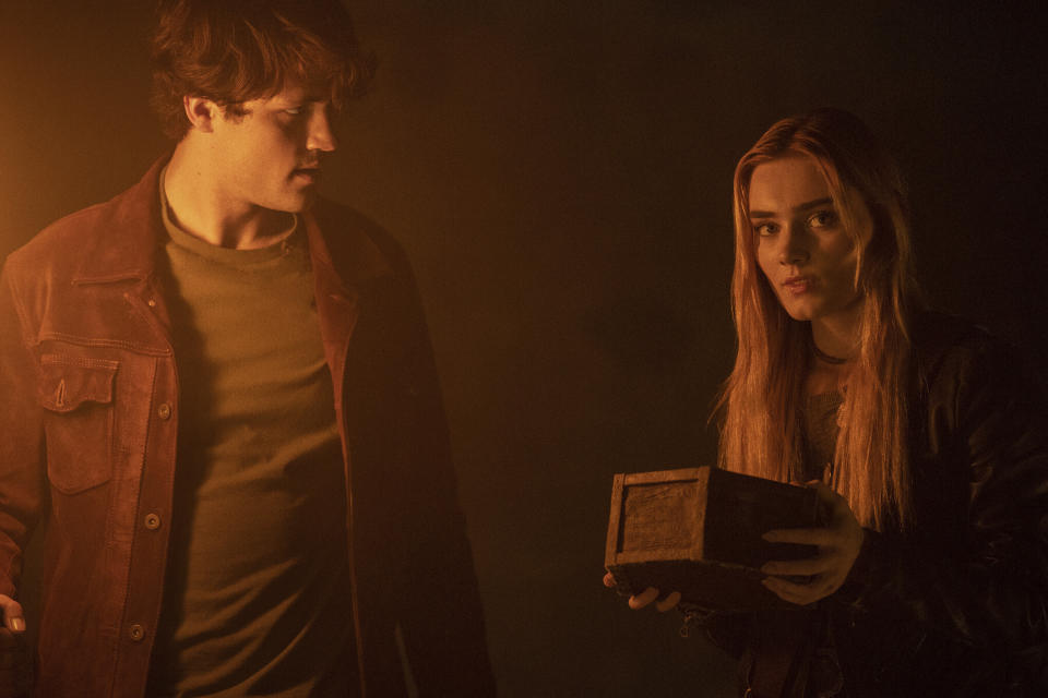 This image released by The CW shows Meg Donnelly, right, and Drake Rodger in a scene from "The Winchesters," a prequel to the long-running series "Supernatural." (Matt Miller/The CW via AP)