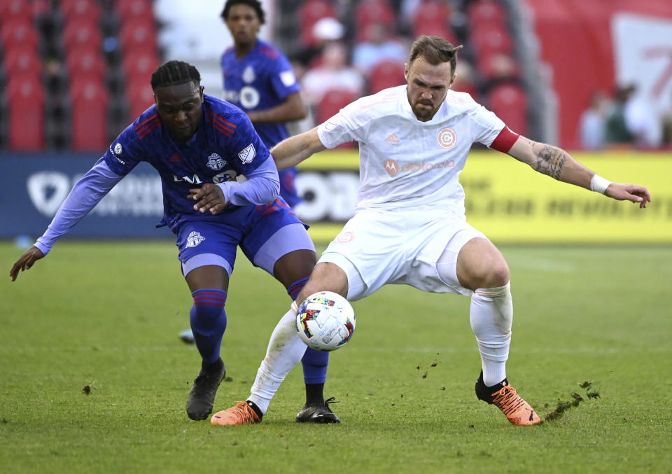 Toronto FC's Ayo Akinola, left, competes for the ball against Chicago Fire's Rafael Czichos during the first half of an MLS soccer match Saturday, May 28, 2022, in Toronto. (Jon Blacker/The Canadian Press via AP)