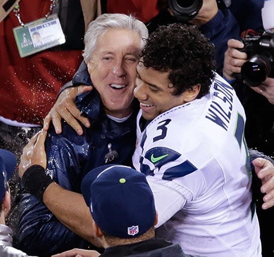 Seattle Seahawks head coach Pete Carroll embraces Russell Wilson after the second half of the NFL Super Bowl XLVIII football game against the Denver Broncos Sunday, Feb. 2, 2014, in East Rutherford, N.J. The Seattle Seahawks won 43-8. (AP Photo/Charlie Riedel)