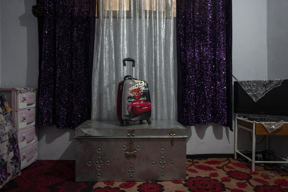 A trunk and a school backpack from a family of Afghan musicians are packed and stored in a living room in Kabul, Afghanistan, Thursday, Sept. 23, 2021. The family fled Afghanistan during the first Taliban term and returned during the first year of the Karzai's government. With the Taliban back in power, the musicians say they don't feel safe and want to return to Pakistan. (AP Photo/Bernat Armangue)