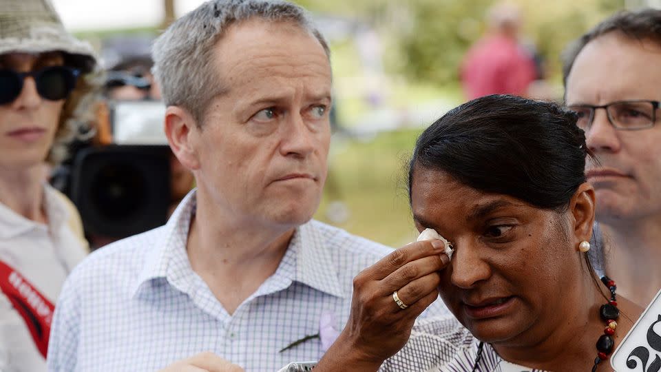 Senator Nova Peris (right) wipes her eyes as Bill Shorten looks on during a press conference in Darwin. Photo: AAP/Mick Tsikas