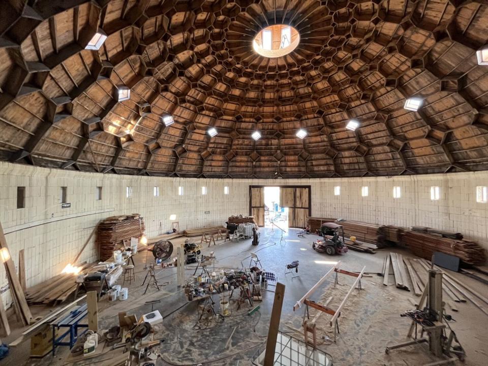 Construction materials sit inside a building with a domed roof