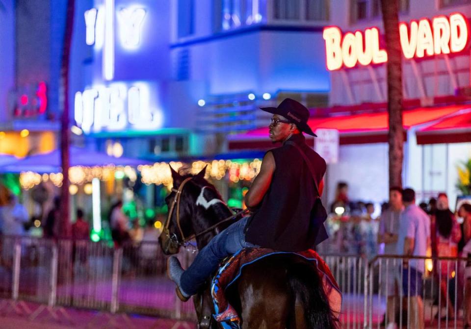 Trainer Stephen Harmon rides his horse Little Bit on Ocean Drive on Friday, March 8, 2024, in Miami Beach, Florida. Harmon is visiting South Florida from South Carolina.