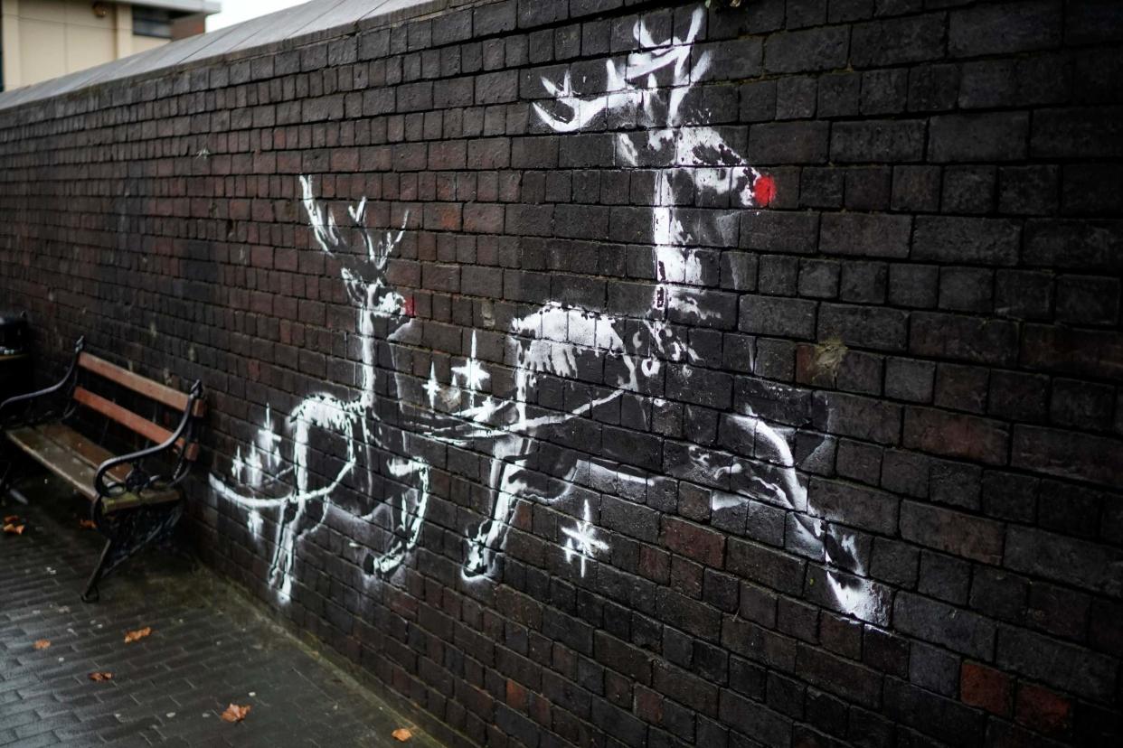 The mural was defaced with a pair of festive red noses: Getty Images