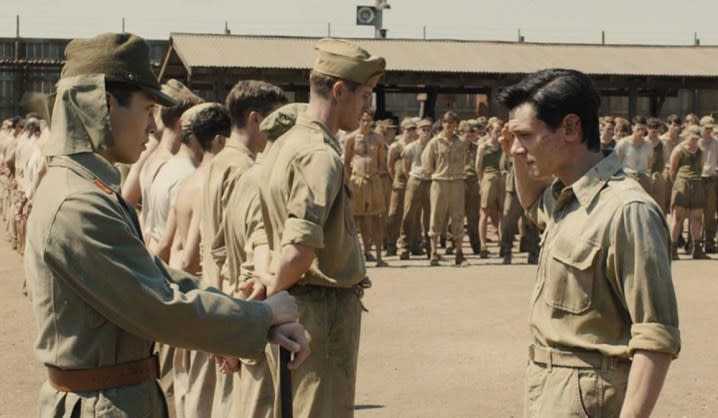 A man faces another man in a POW camp in Unbroken.