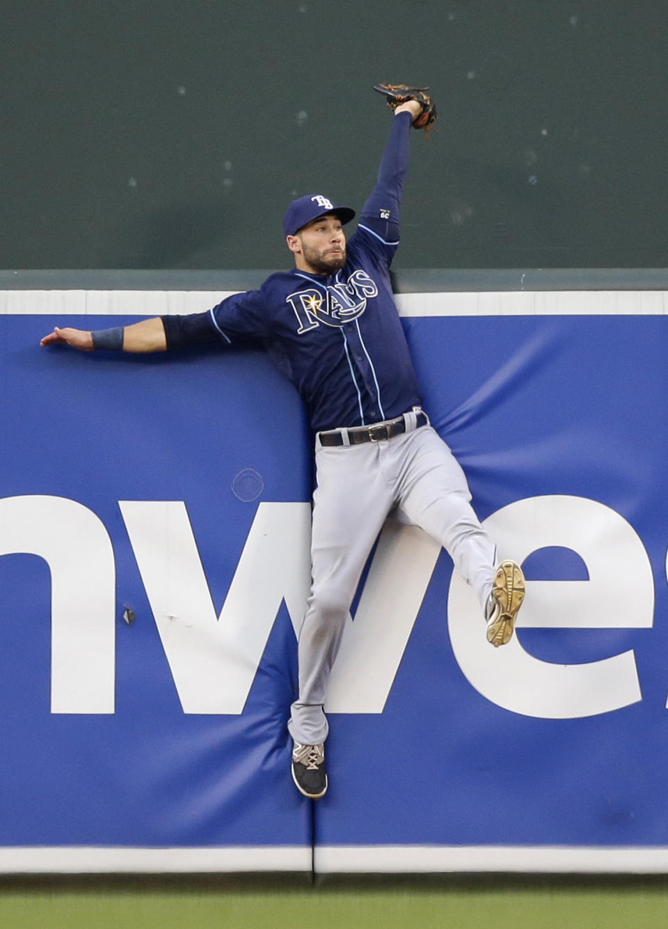 FILE - In this Monday, Aug. 31, 2015 file photo,Tampa Bay Rays center fielder Kevin Kiermaier collides with the outfield wall after catching a fly ball by Baltimore Orioles' Manny Machado in the first inning of a baseball game in Baltimore. Everyone has seen an outfielder receive a tip of the cap or a jubilant fist bump from a pitcher after a home run robbery. This is a story about what happens after they leave the field. (AP Photo/Patrick Semansky, File)