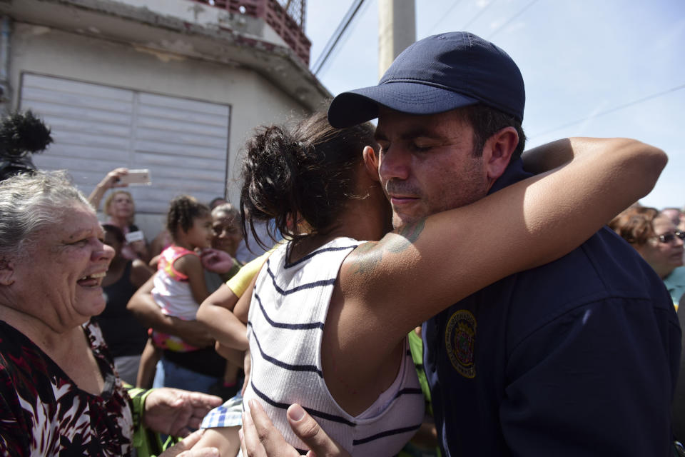 A San Juan resident hugs Gov. Ricardo Rosselló as the National Guard arrives at Barrio Obrero in Santurce to distribute water and food to those affected by Hurricane Maria in September 2017. (Photo: Carlos Giusti/AP)