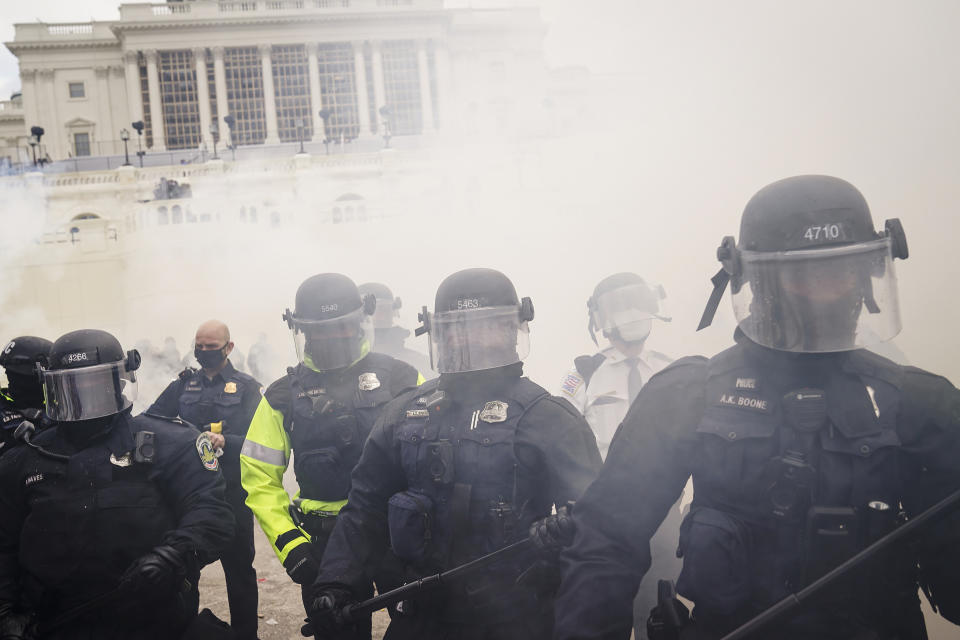 FILE - Supporters loyal to President Donald Trump clash with authorities before successfully breaching the Capitol building during a riot on the grounds, Wednesday, Jan. 6, 2021. Federal authorities say a Southern California man who assaulted police with pepper spray during the storming of the U.S. Capitol was sentenced to 4 1/2 years in prison. The U.S. Department of Justice said in a statement Friday, April 28, 2023, that Jeffrey Scott Brown of Santa Ana, Calif., received a sentence of 54 months. (AP Photo/John Minchillo, File)