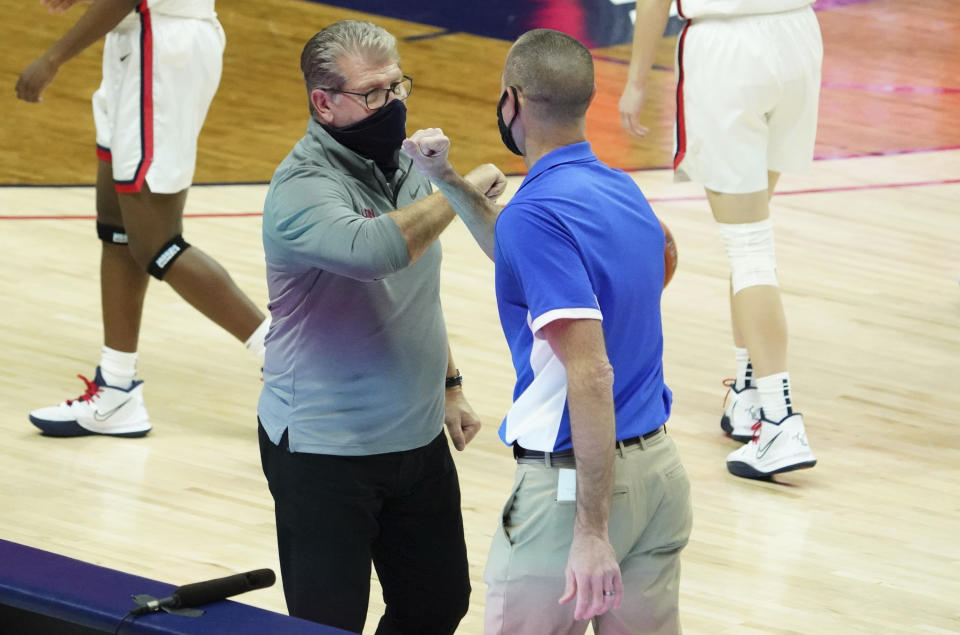 Connecticut head coach Geno Auriemma, left, and Creighton head coach Jim Flanery meet after an NCAA college basketball game in Storrs, Conn., Thursday, Dec. 17, 2020. (David Butler II/Pool photo via AP)