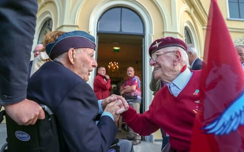 Former paratrooper Sandy Cortmann (right) from Aberdeen, talks to Canadian veteran Lloyd Bentley during an emotional return to Arnhem - Credit: Steve Parsons/PA