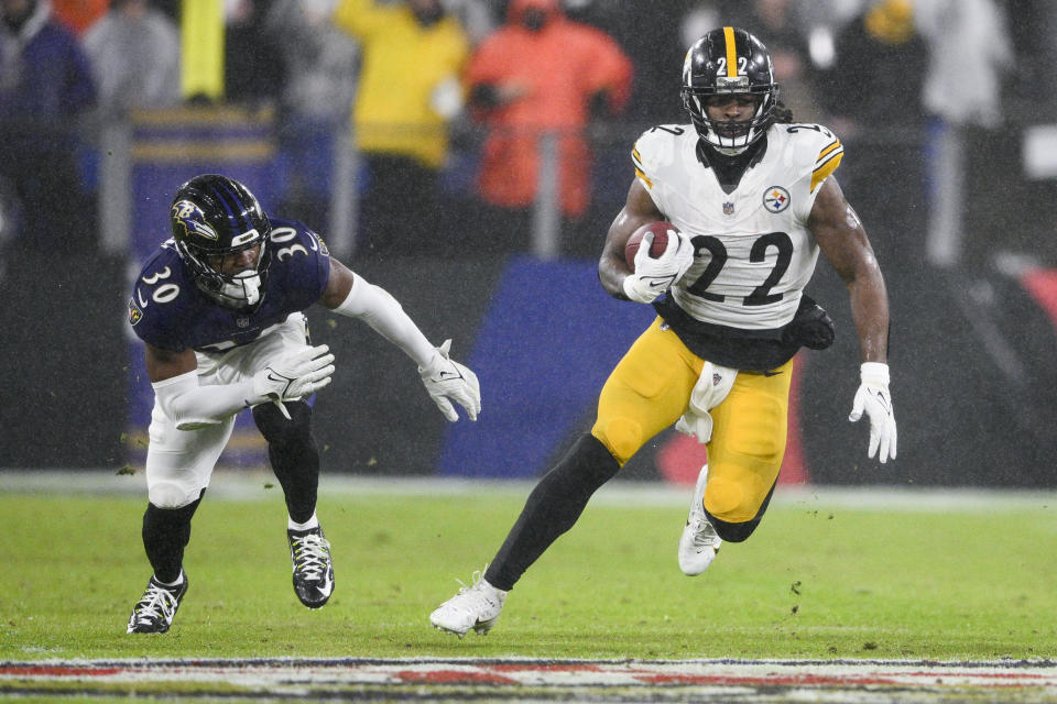 Pittsburgh Steelers running back Najee Harris (22) runs with the ball against Baltimore Ravens linebacker Trenton Simpson (30) during the second half of an NFL football game, Saturday, Jan. 6, 2024 in Baltimore. (AP Photo/Nick Wass)