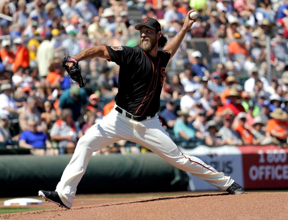 San Francisco Giants starting pitcher Madison Bumgarner throws against the San Diego Padres during the first inning of a spring training baseball game, Tuesday, March 21, 2017, in Scottsdale, Ariz. (AP Photo/Matt York)