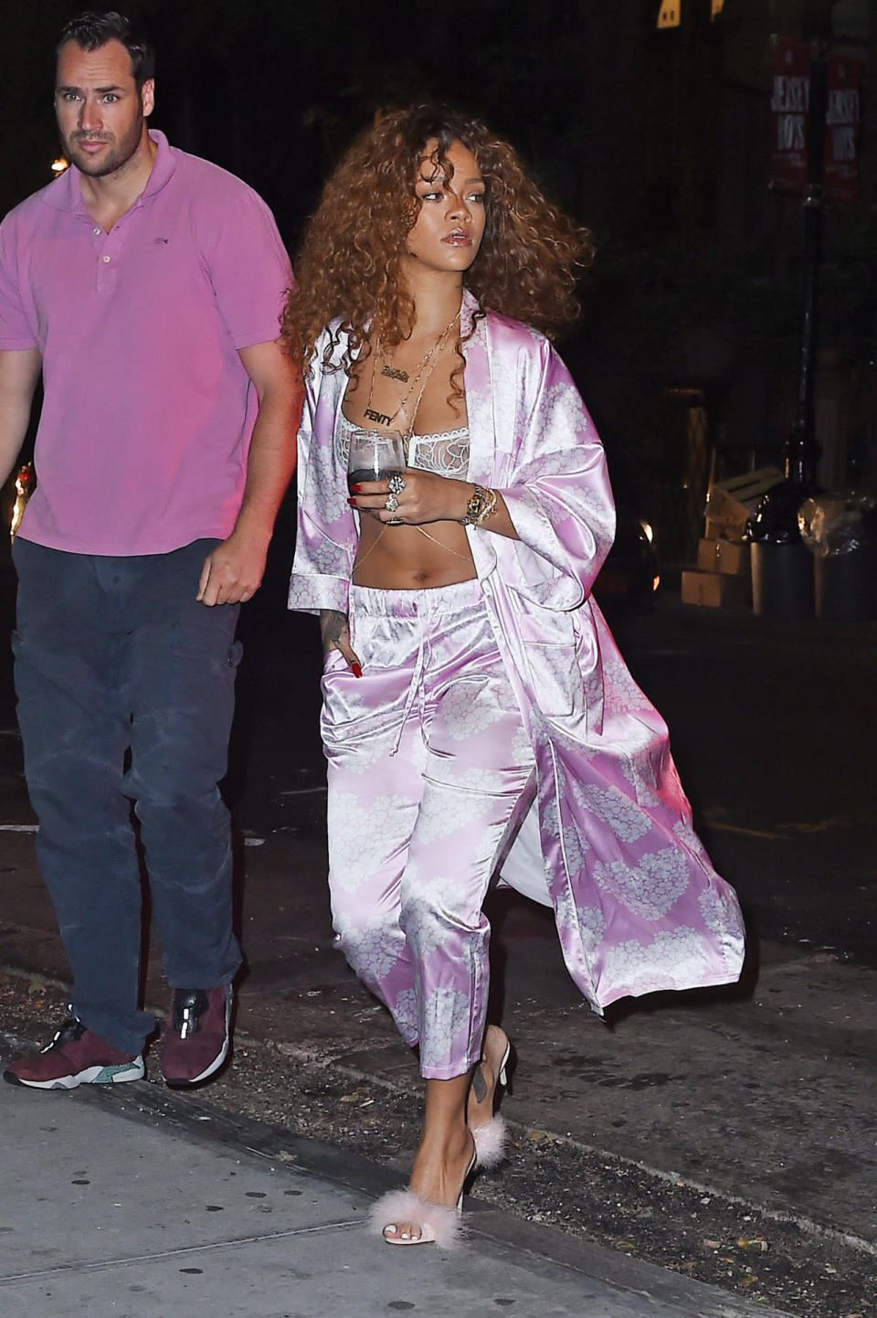 Rihanna made her way to a recording studio in July 2015 wearing pink and white silk pajama bottoms, a matching robe, a lace bralette, and fuzzy heels. 