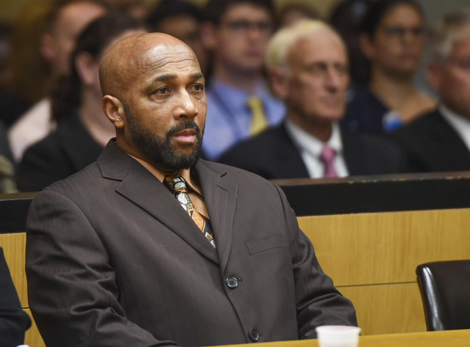 Keith Bush sits at the defense table during a hearing at Suffolk County Courthouse in Riverhead, N.Y., to have his 1975 murder conviction vacated, Wednesday, May 22, 2019. Bush, who spent 33 years in prison for murdering a high school classmate, had his conviction overturned Wednesday after a case review found Long Island prosecutors had long hid the fact that police looked at another possible suspect. (James Carbone/Newsday via AP, Pool)