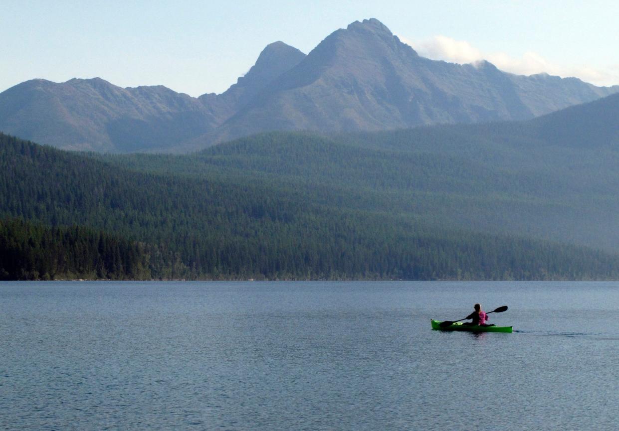 In this Sept. 6, 2013, file photo, a woman kayaks on Kintla Lake in Glacier National Park, Mont.