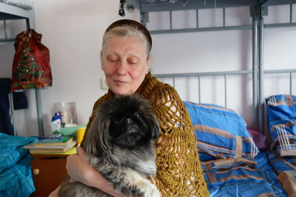 In this photo released by Belgorod regional governor Vyacheslav Gladkov's Telegram channel on Wednesday, March 20, 2024, a resident deported from a settlement bordering Ukraine sits at a temporary accommodation center in Stary Oskol, Belgorod region, Russia. (Belgorod Region Governor Vyacheslav Gladkov Telegram channel via AP)