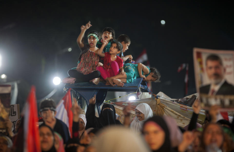 Supporters of Egypt's ousted President Mohammed Morsi chant slogans as they attend a protest outside Rabaah al-Adawiya mosque, where protesters have installed a camp and hold daily rallies at Nasr City in Cairo, Egypt, Thursday, Aug. 1, 2013. (AP Photo/Khalil Hamra)