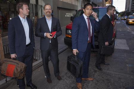Adam Messinger (2nd L), Twitter's chief technology officer, and Nils Erdmann (L), director of investor relations of Twitter, depart Morgan Stanley in advance of the firm's IPO in New York, October 25, 2013. REUTERS/Carlo Allegri