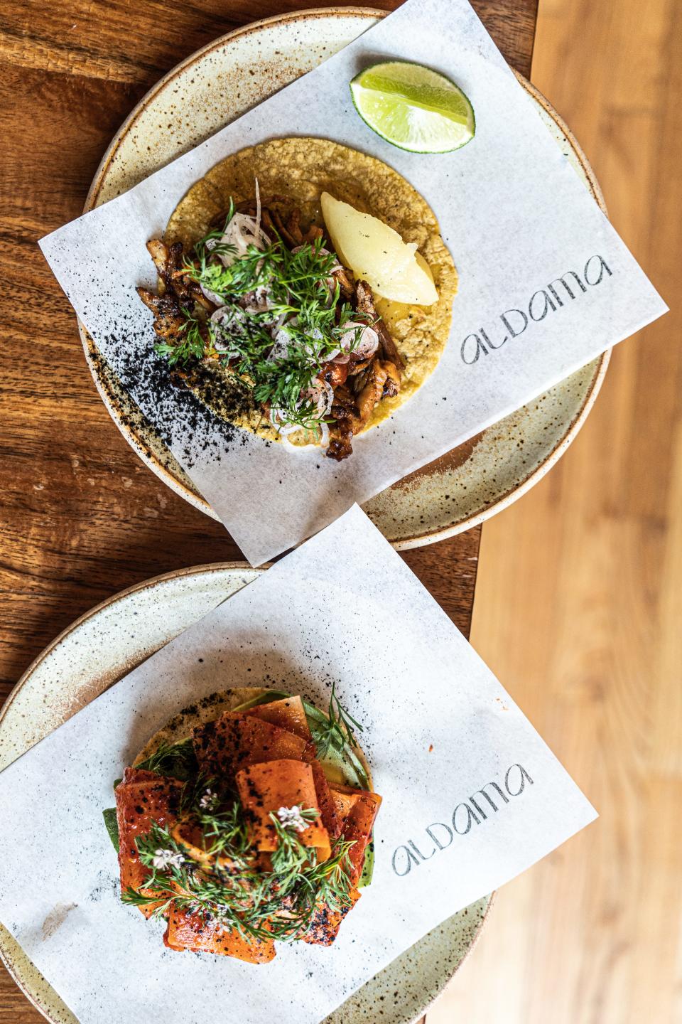 One plate with a taco and one with a tostada.