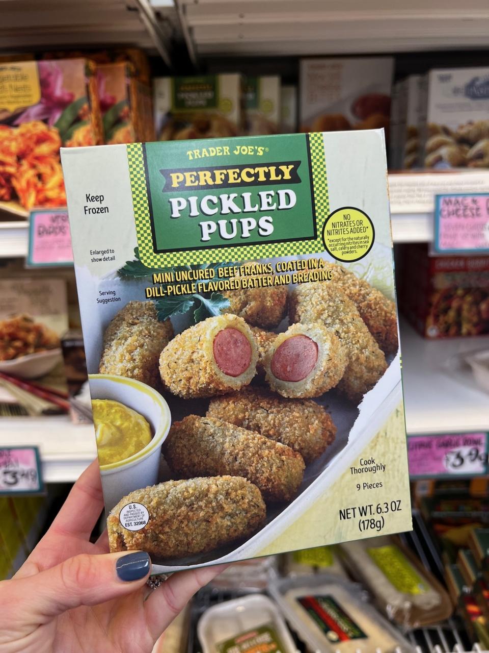 A box of Perfectly Pickled Pups: "mini uncured beef franks, coated in a dill-pickle flavored batter and breading"